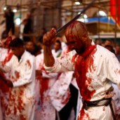 Iraq Shi'ite Muslim men bleed as they gash their foreheads with swords and beat themselves during the religious festival of Ashura in Najaf