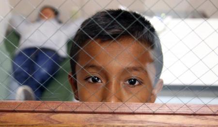 immigrant child behind cage